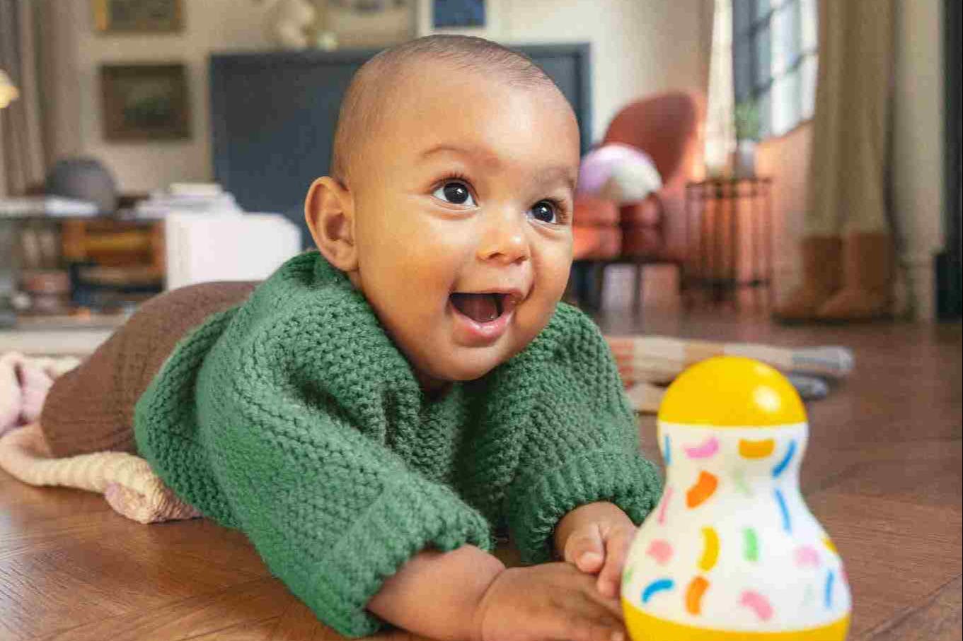 Baby playing with the Tummy Time Wobbler from The Senser Play Kit