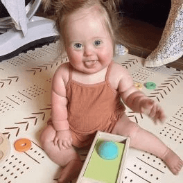 Child sitting with the Sliding Top Box from The Thinker Play Kit