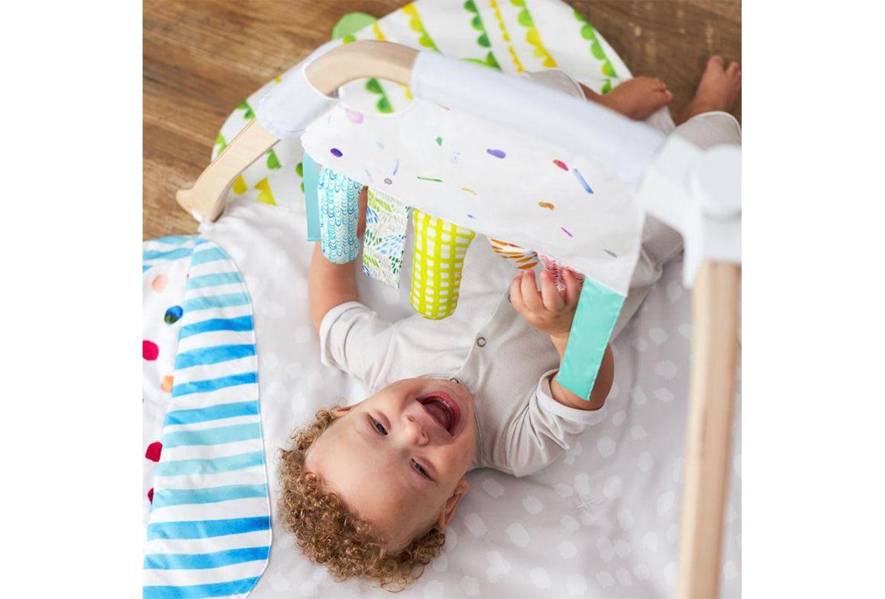 Baby playing with the Sensory Strands by Lovevery