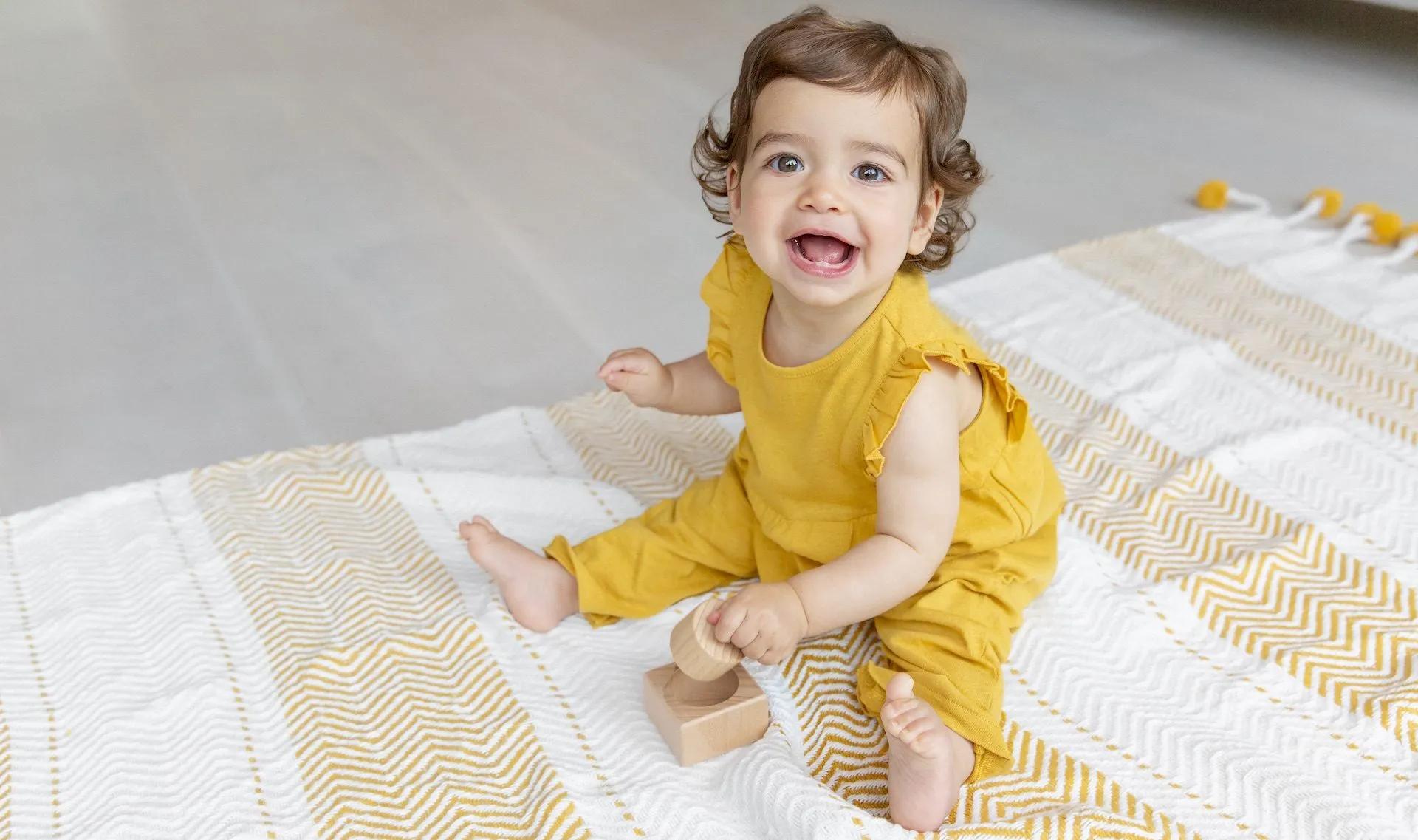 Baby playing with the Pincer Puzzle from The Thinker Play Kit